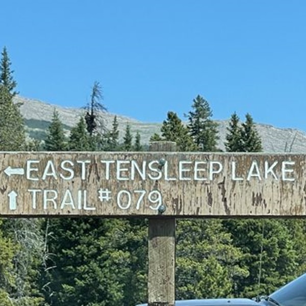 The trail begins at East Ten Sleep Lake, a scenic alpine lake sitting at over 9,000 feet in elevation, known for its reflective waters and surrounding granite peaks. 