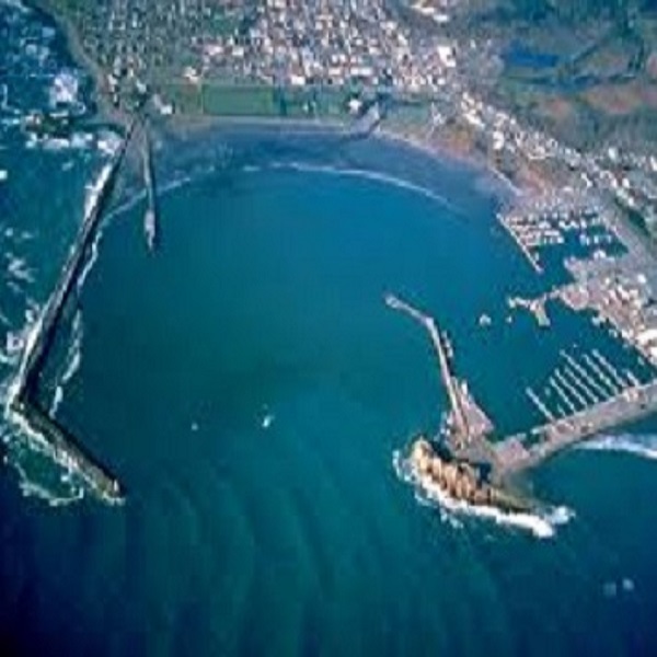 Aerial view of Crescent City Harbor with Battery Point Lighthouse in the top left corner