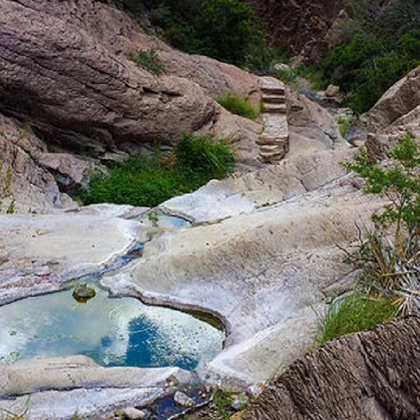 The streambed is polished smooth by occasional floods and the seasonal creek forms shallow pools and small cascades. 