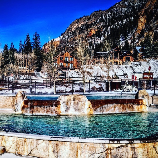 The pool is equipped with water slides, a rock wall, and an obstacle course, making it a fun destination for families. 