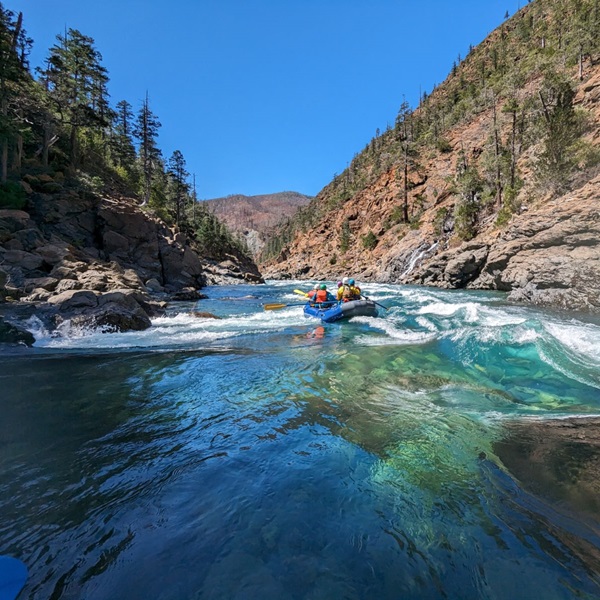 The river winds through the Smith River National Recreation Area, showcasing the ancient redwood forests, dramatic gorges, and rugged terrain. 