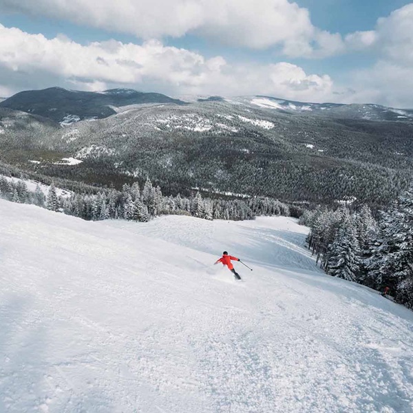 The resort, with a vertical drop of 2,110 feet, offers 22 named runs over 1,000 acres of skiable terrain, catering primarily to intermediate and advanced skiers and snowboarders. 
